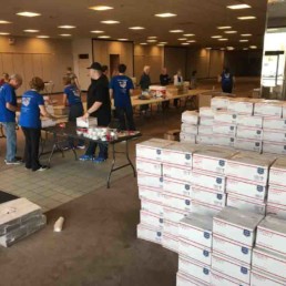 volunteers packing boxes in donated shopping center space